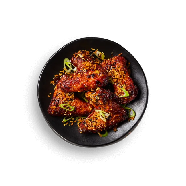 Wagamama buldak fire wings, spicy buldak sauce, crispy and spring onions and sesame seeds