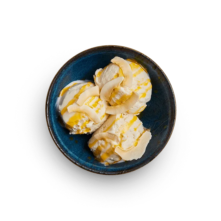 Wagamama coconut reika ice cream, three scoops with coconut flakes and passion fruit sauce