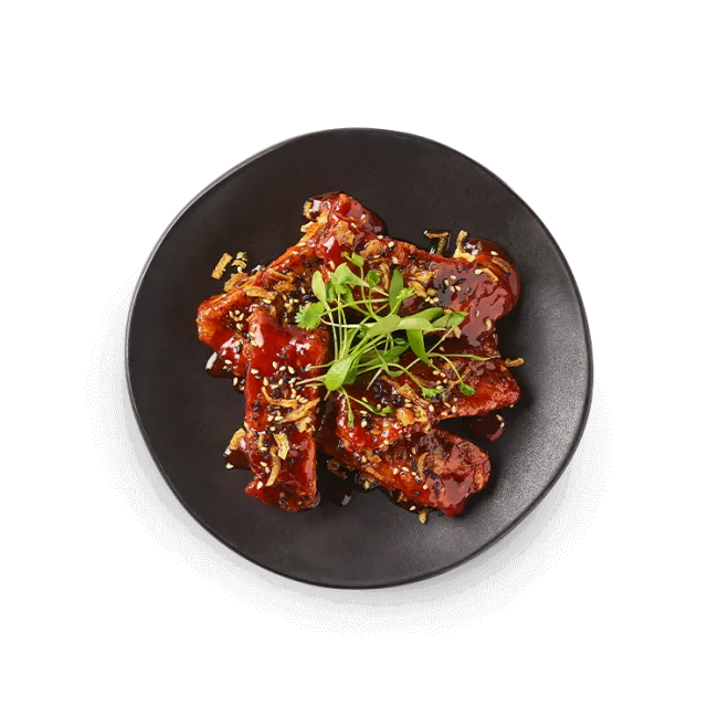 Wagamama gochujang tamarind pork ribs, (on the bone), sticky gochujang tamarind sauce, crispy onions and coriander cress