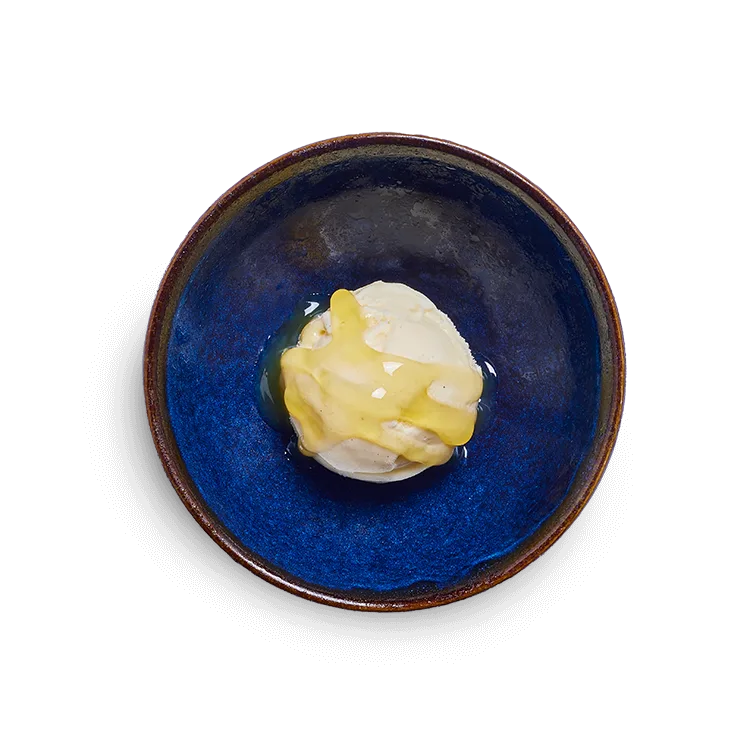 Wagamama kids vanilla pod ice cream with passion fruit sauce, one scoop of vanilla ice cream and passion fruit sauce